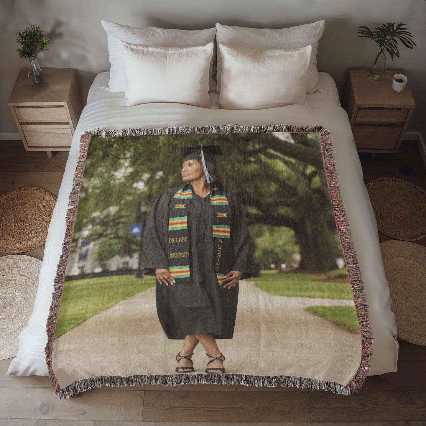 Photo of a graduate in cap and gown on a blanket, symbolizing achievement and celebration.