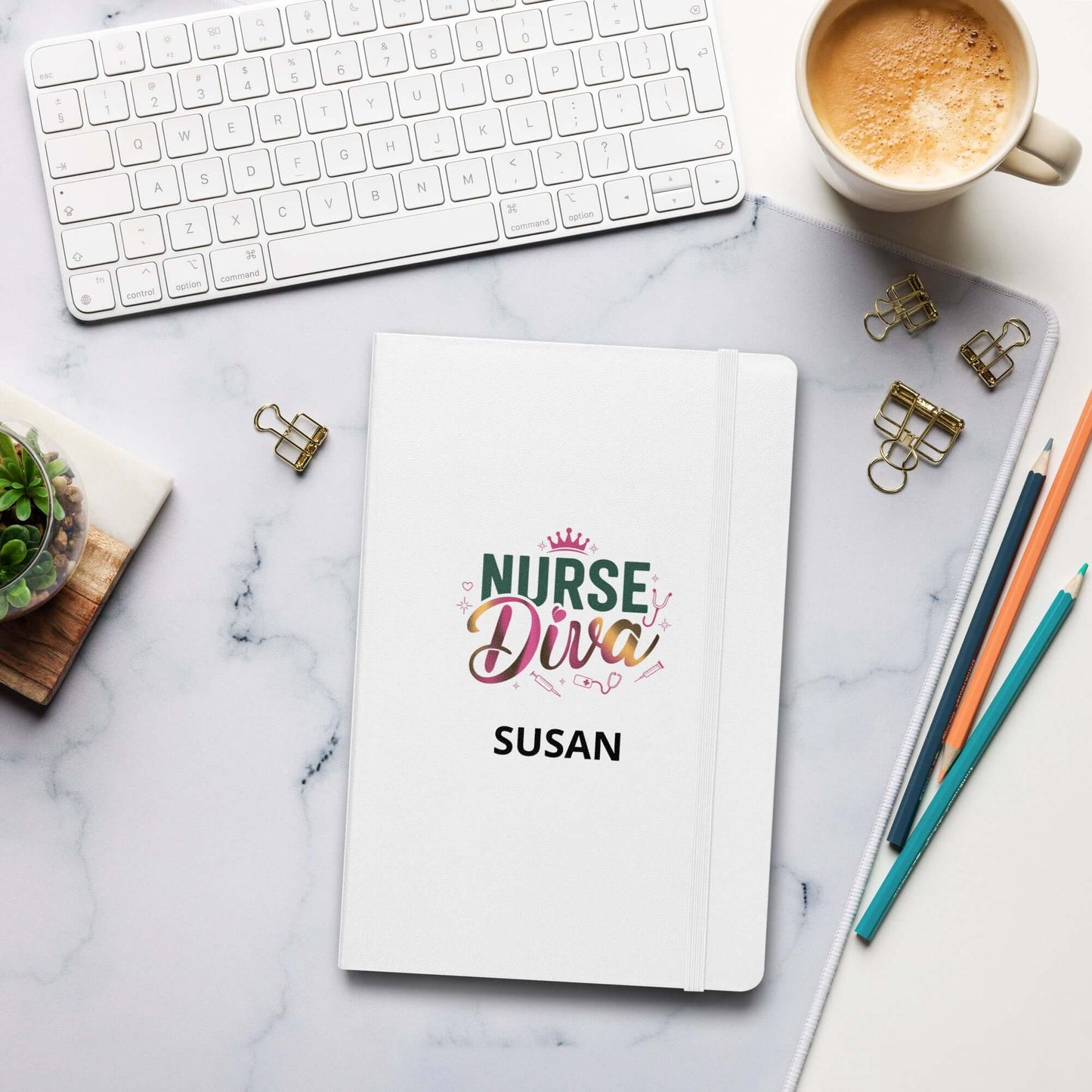 Personalized 'Nurse Diva' hardcover notebook with name 'Susan' on a stylish marble desk, featuring a coffee cup, keyboard, and office supplies.