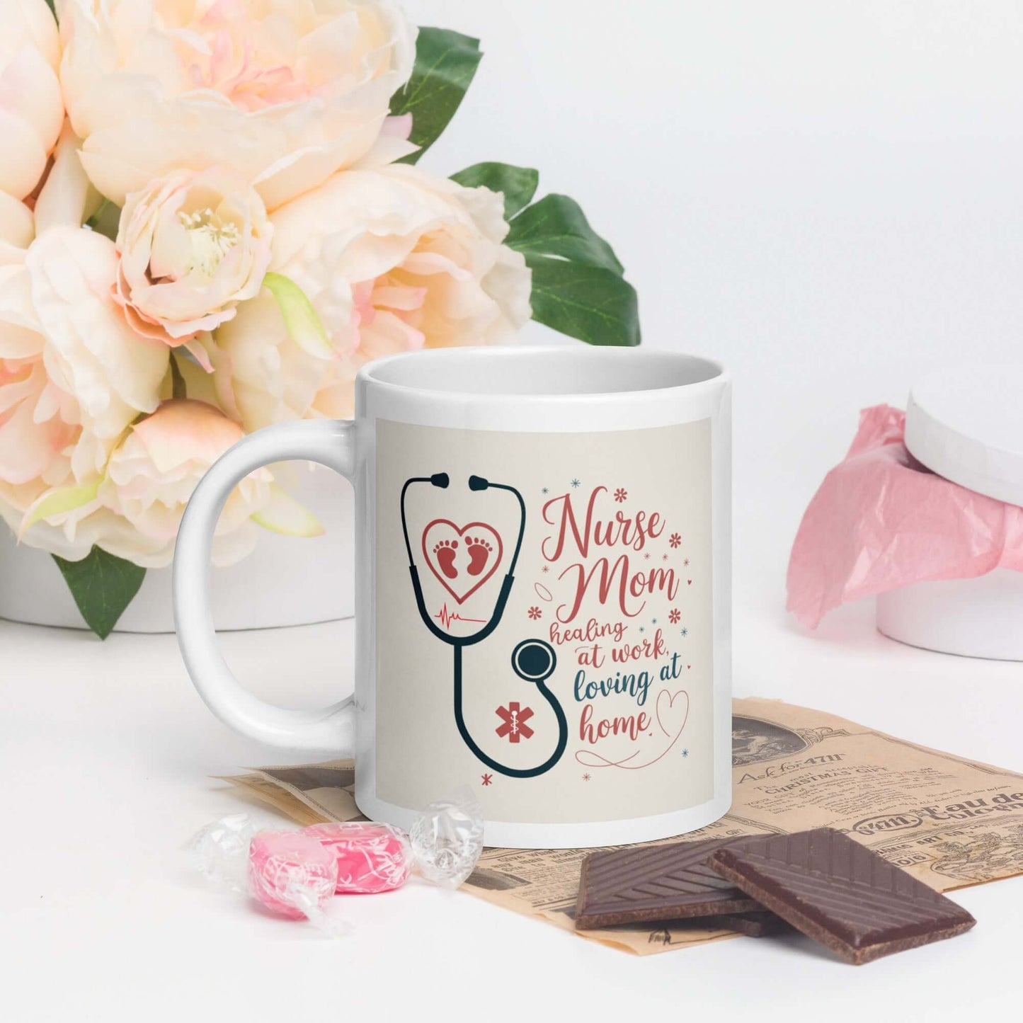 Nurse Mom coffee mug with stethoscope heart design and heartfelt quote, surrounded by chocolates, candies, and soft pink flowers – perfect gift for nurse moms.