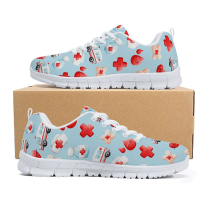 A pair of light blue "Ambulance Sneakers: Fun shoes for nurses" featuring white soles and a healthcare-themed pattern. The design includes images of red crosses, ambulances, medical pills, hearts with heartbeats, and stethoscopes. These comfortable sneakers are displayed on top of a brown shoebox.