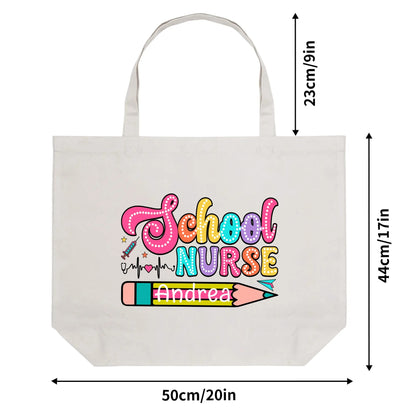 Presenting the Personalized 100% Cotton Tote Bag for School Nurses: a white tote bag with dimensions of 50cm/20in wide, 44cm/17.1in tall, and 23cm/9in deep. It features colorful text reading "School Nurse" alongside a decorative pencil and medical heartbeat line design. The name "Andrea" is elegantly written in green on this eco-friendly material, making it the perfect gift for school nurses.