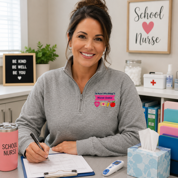 School nurse wearing a custom fleece pullover while working at her office desk