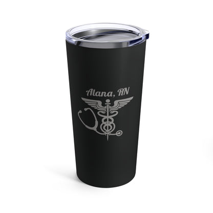 Introducing the Personalized 20oz Tumblers for Medical Professionals: a sleek black travel tumbler with a clear lid, featuring a custom design that reads "Alana, RN" along with a metallic silver caduceus symbol and stethoscope—perfect as an ideal gift for healthcare heroes. This custom tumbler offers stylish, personalized hydration for dedicated medical professionals.