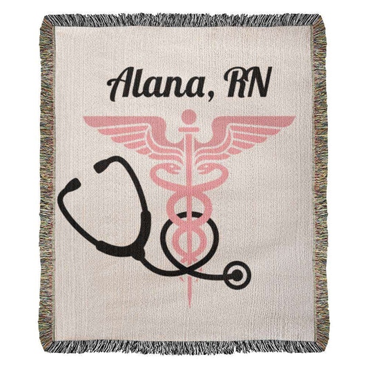 A woven throw blanket featuring the text "Alana, RN" at the top. Below the text, there is a pink caduceus symbol and a black stethoscope. This Personalized Nurse Heirloom Woven Blanket - Custom Keepsake for Healthcare Heroes is perfect for nursing school graduates, with its decorative multicolored fringe on the edges.