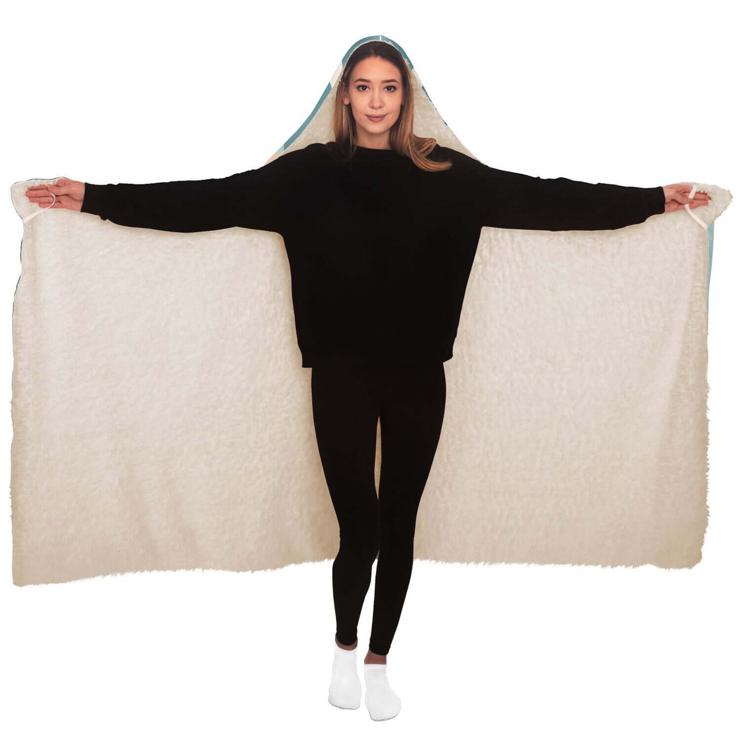 A person in black clothing stands with arms outstretched, displaying a large beige hooded blanket. With its soft, plush texture, this Personalized Nurses Hooded Blanket makes an ideal nurse gift for comfort and relaxation. The person wears white socks, standing against a plain white background.