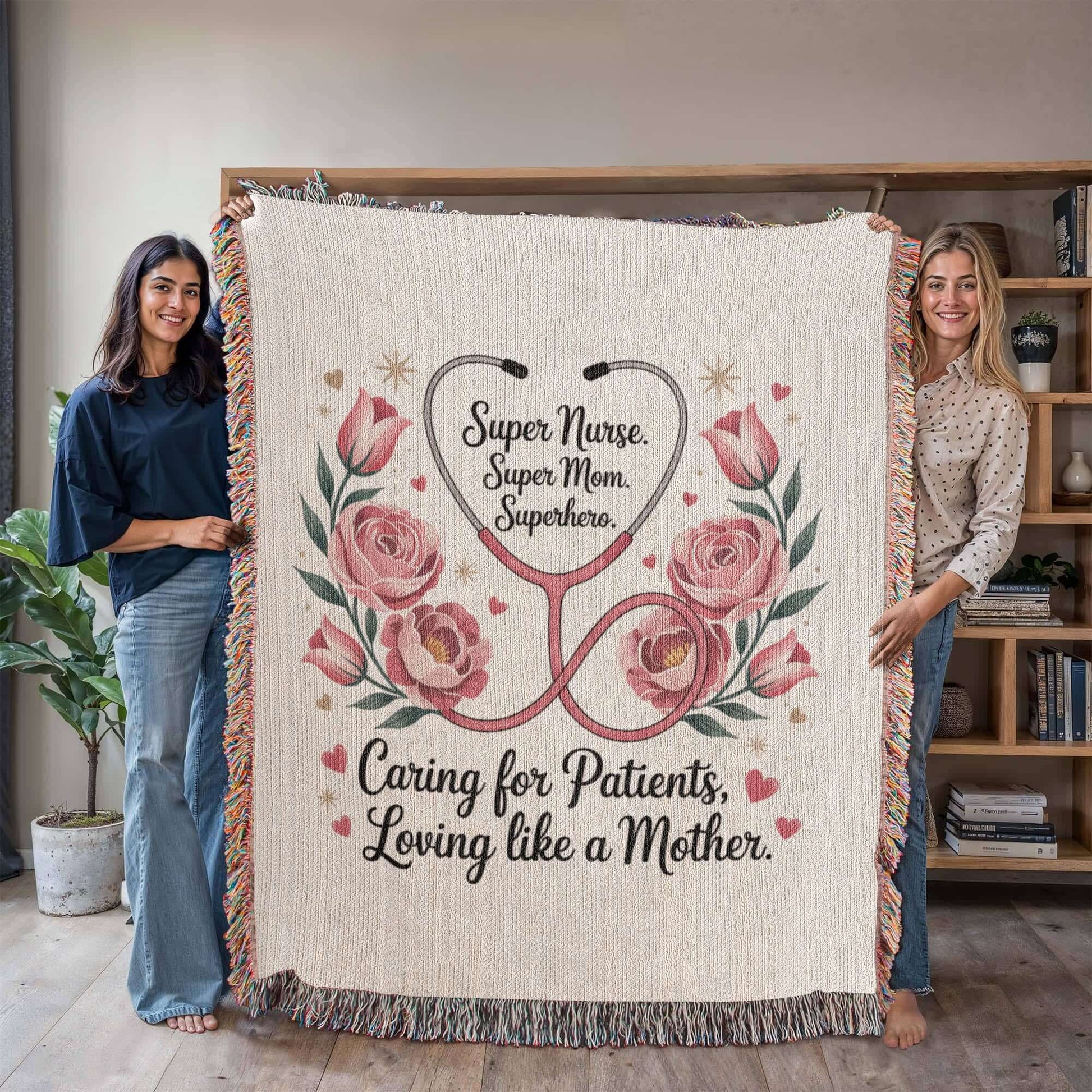 A decorative blanket features pink roses, a stethoscope forming a heart, and the words "Super Nurse. Super Mom. Superhero. Caring for Patients, Loving like a Mother" in elegant script.